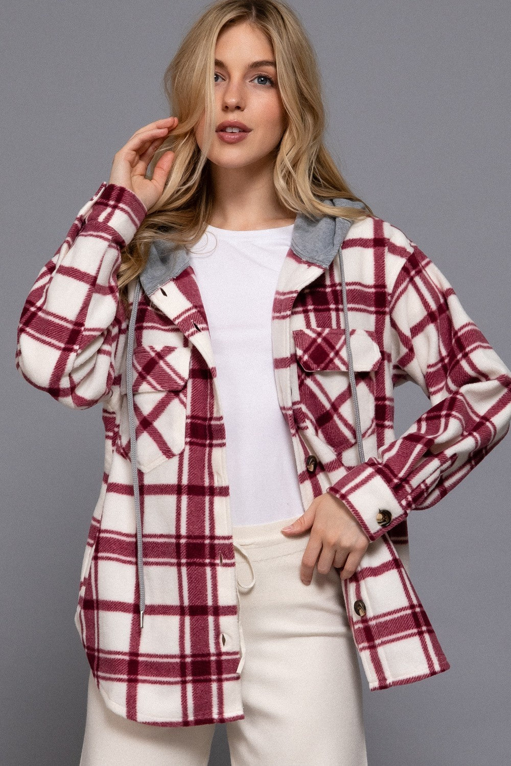 model wearing a burgundy and white plaid shacket with gray hood