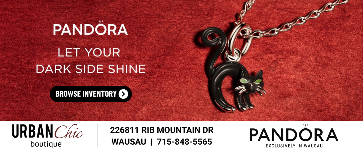 Pandora cat pendant necklace in black enamel with green eyes on a silver chain, set against a textured red background with promotional text and a white footer bar showing Urban Chic boutique details.