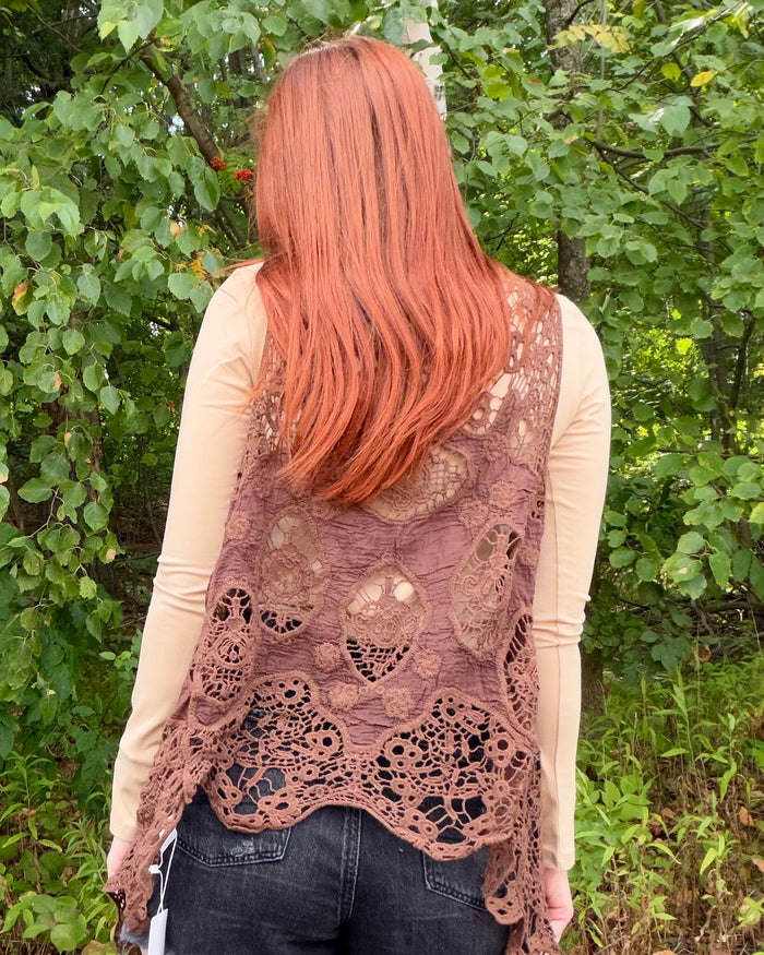 back of brown crochet vest on model
