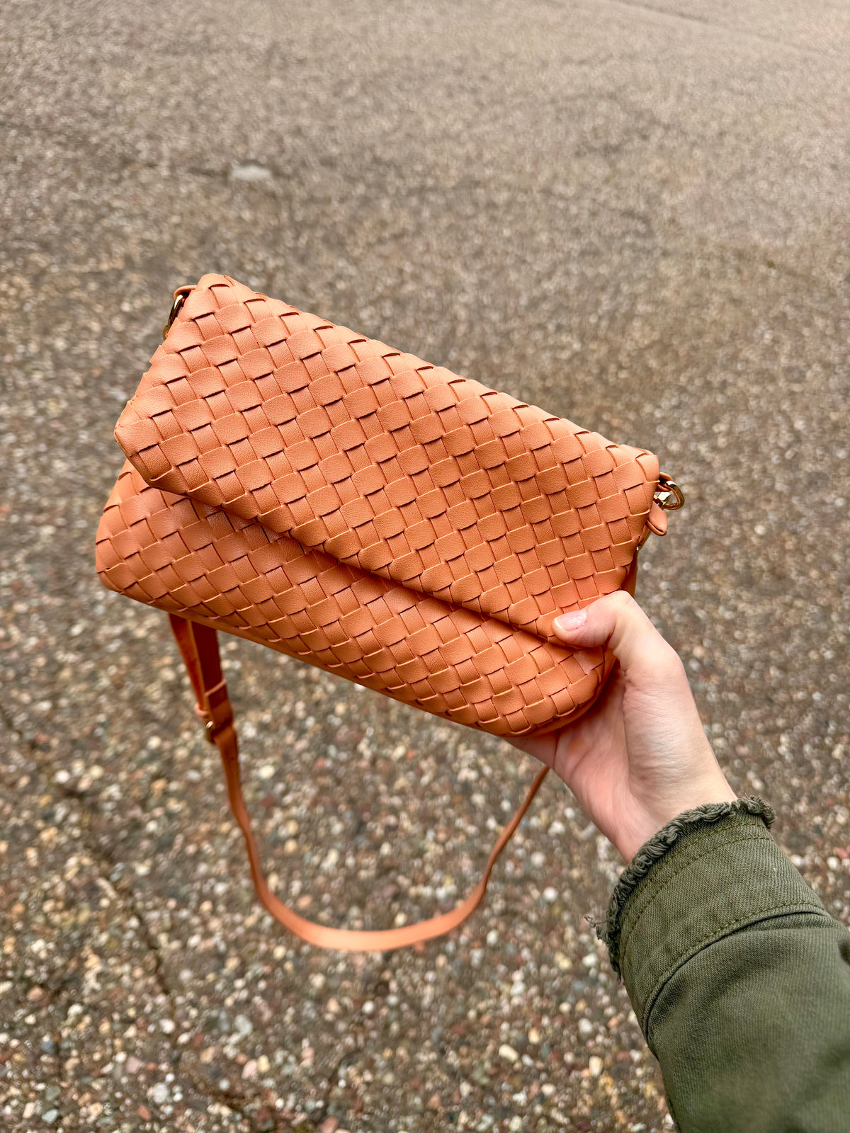nat woven flapover crossbody bag in a coral color